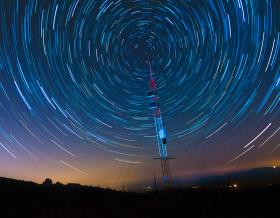 time lapse image of stars moving around sky