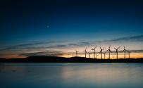Wind turbines over water at night