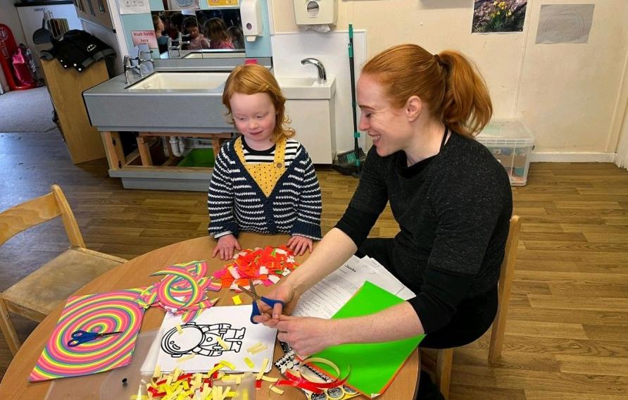 Rachael Cassidy and a young girl work on a STEAM activity